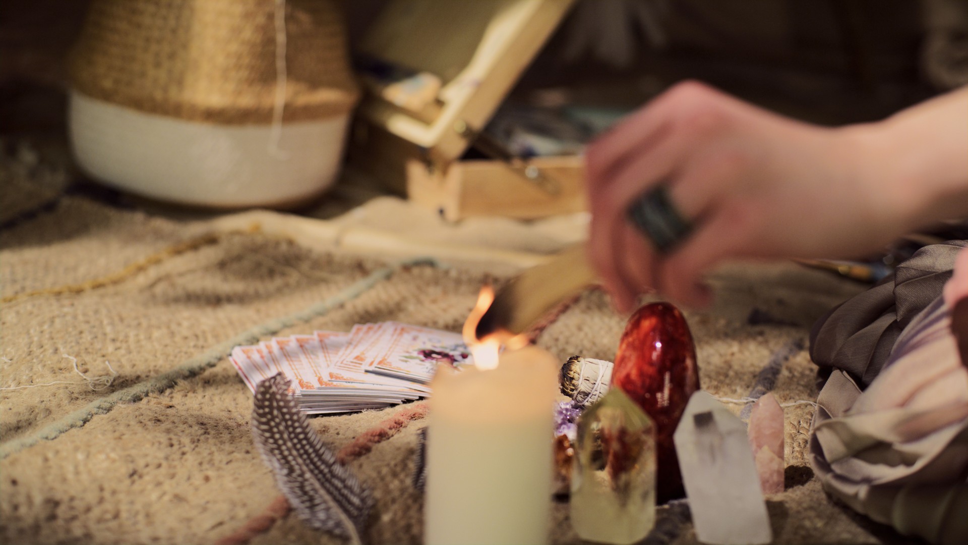 Meditative space in desert tent. Serene woman smudging with palo santo. Close up on hands