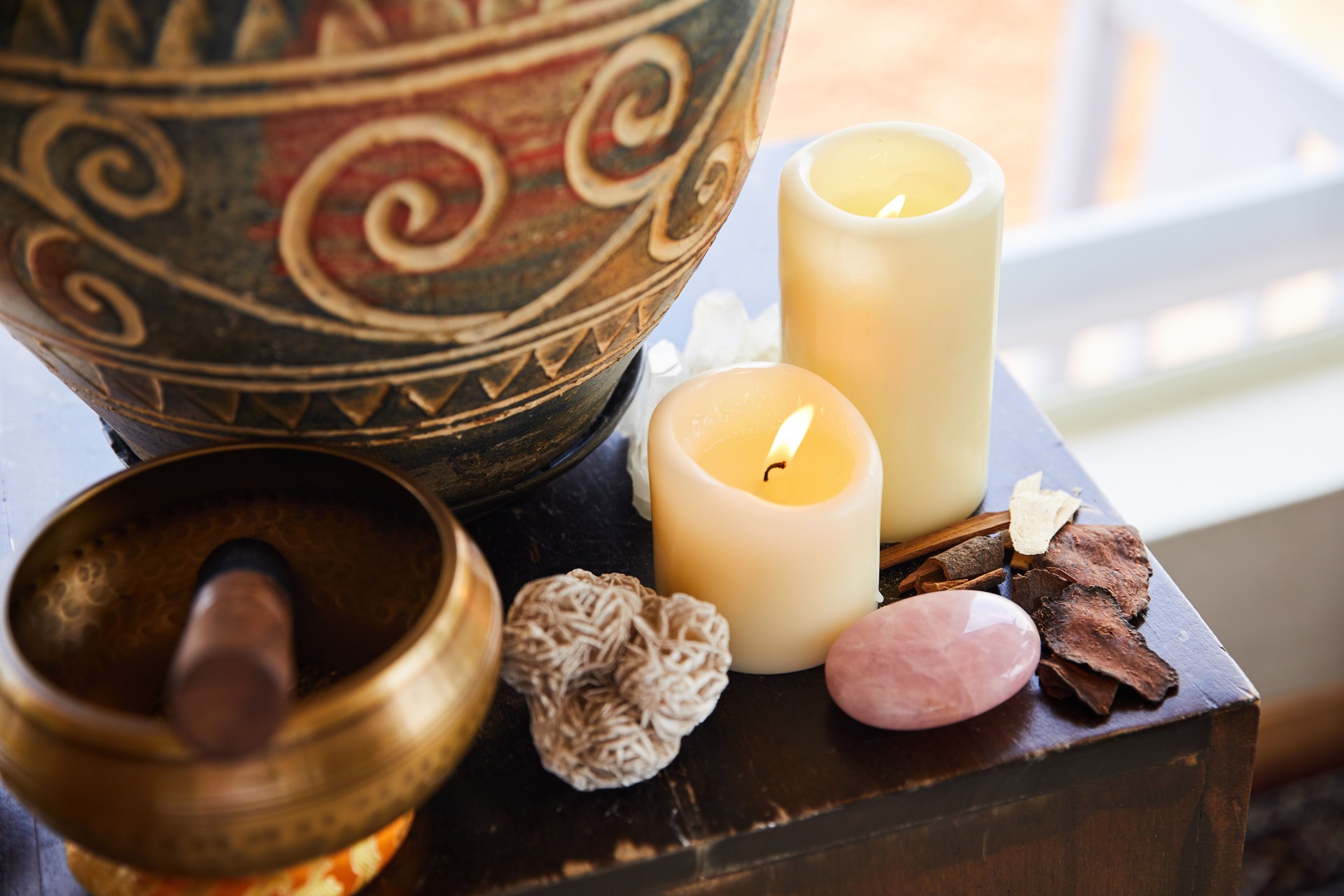 Spiritual healing items sitting together on a yoga studio table